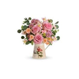 Pink and peach rose bouquet in a decorative vase