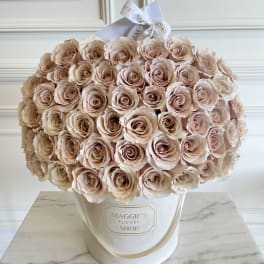Large bouquet of blush roses in a white hat box with a ribbon bow