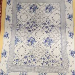 Blue-and-white floral quilt with patchwork diamond pattern