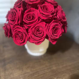 Bouquet of bright red roses in a white vase