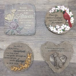 Four memorial stone plaques with floral accents and sympathy messages