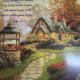 Decorative cottage scene with a Bible verse and flower beds
