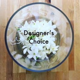 White flowers in a round clear box with "Designer's Choice" text