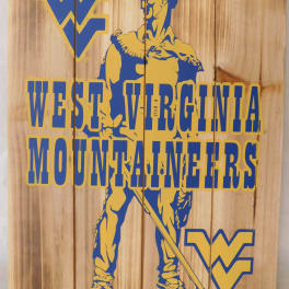 West Virginia Mountaineers logo on a wooden sign