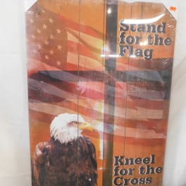 Decorative sign with an American flag and eagle, reading "Stand for the Flag" and "Kneel for the Cross".