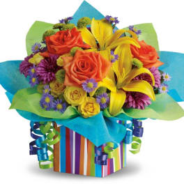 Colorful bouquet of roses and lilies in striped gift wrap
