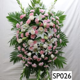 Standing floral spray with white lilies, white roses, and pink carnations
