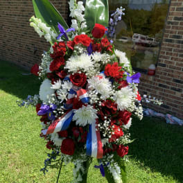 Large standing floral spray with red, white, and purple flowers