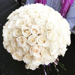 Large bouquet of white roses held by a person