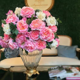 Pink and white flower arrangement in a glass vase