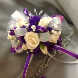 White roses and purple flowers with silver and purple ribbons
