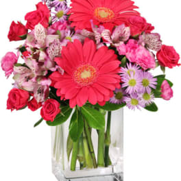 Pink and purple mixed bouquet in a clear glass vase