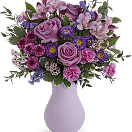 Pink and purple mixed bouquet in a lavender vase