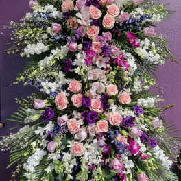 Large standing floral spray with pink and purple roses and orchids