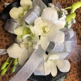 White orchid bouquet with silver ribbon and black wrap