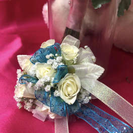 Small bouquet of white roses with blue and silver ribbon accents