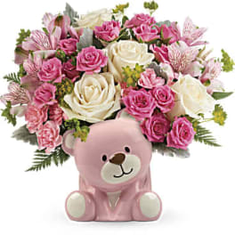 Pink and white rose bouquet in a pink teddy bear container
