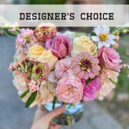 Pastel bouquet of roses and mixed blooms in a glass vase
