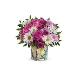 Pink roses and white daisies in a patterned square vase