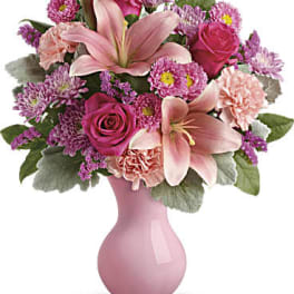 Pink lilies and roses in a pink vase