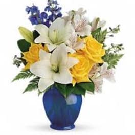 Bouquet of white lilies and yellow roses in a blue vase
