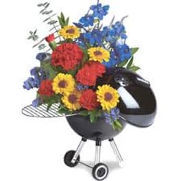 Colorful flower arrangement in a black kettle-style grill