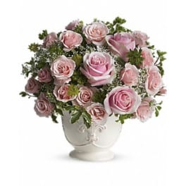 Pink roses arranged in a white decorative vase