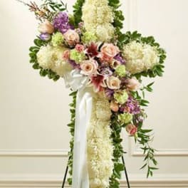 Standing floral spray with white and pastel flowers on a white ribboned easel