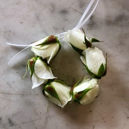 White rose bud wrist corsage with ribbon ties