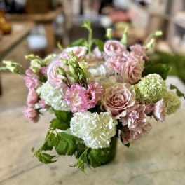 Pink and white floral arrangement with roses and hydrangeas in a vase