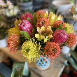 Bouquet of pink protea and yellow-orange pincushion flowers