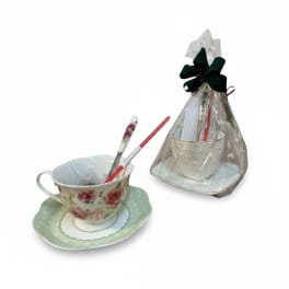 Two teacup-and-saucer gift sets wrapped in clear plastic