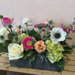 Mixed flower arrangement in a rectangular black container