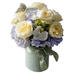 Cream roses and lavender hydrangeas in a wrapped bouquet with butterfly accents