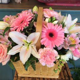 Pink and white mixed flower basket with lilies, gerberas, roses, and carnations