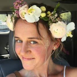 Woman wearing a floral crown with white and pale pink flowers