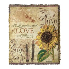 Decorative woven blanket with a sunflower and the words "LOVE will follow me"