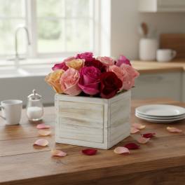 Mixed roses arranged in a white wooden box on a table