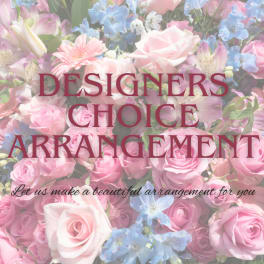 Pink roses and blue flowers with overlaid text reading Designers Choice Arrangement