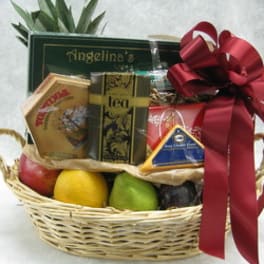 Gift basket with tea, fruit, and a red ribbon bow