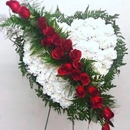 Heart-shaped standing spray of white flowers with red roses