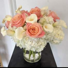 Pink roses and white calla lilies in a glass vase