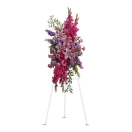 Tall pink and purple floral spray on a white easel