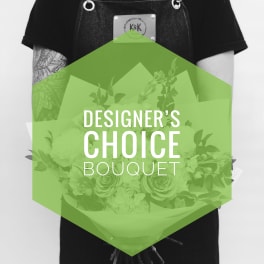 Person holding a bouquet wrapped in paper with "Designer’s Choice Bouquet" text
