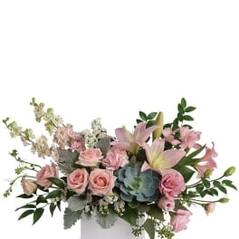 Pink lilies and roses in a white rectangular vase