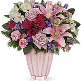 Pink and white mixed flower arrangement in a pink glass vase