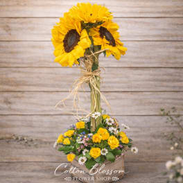 Sunflower arrangement in a rustic wooden box with yellow roses and daisies
