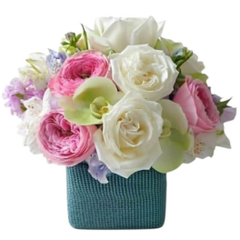 Pink and white roses with pale green orchids in a blue vase