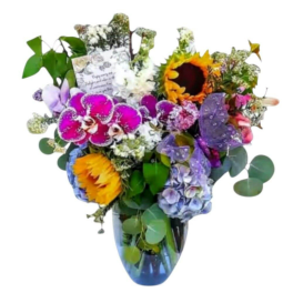 Colorful bouquet with sunflowers, orchids, and hydrangeas in a blue vase