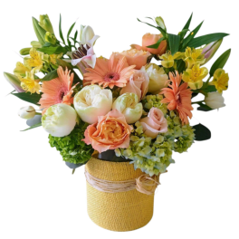 Peach and yellow mixed bouquet in a burlap-wrapped vase